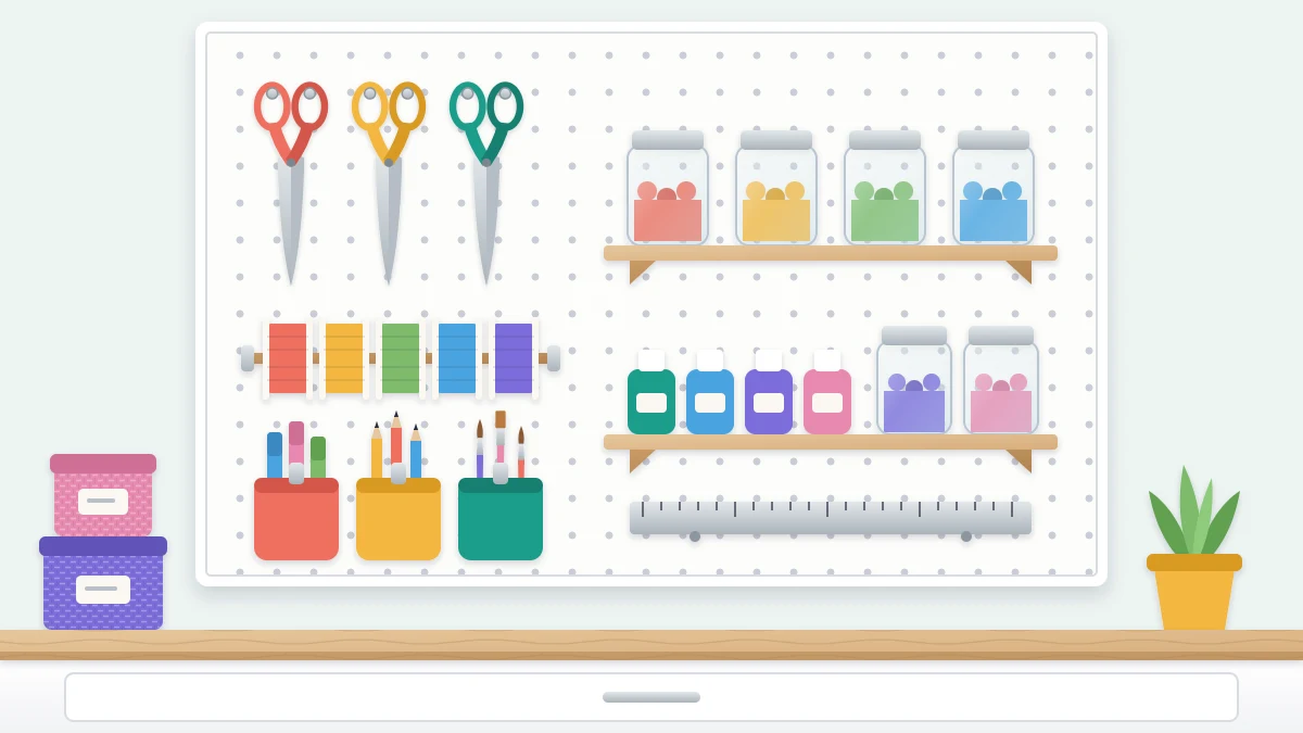 A white pegboard panel above a desk holding scissors on hooks, two small shelves with jars, three hanging cups and a bar of ribbon spools