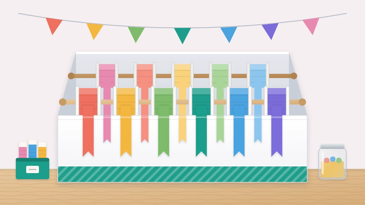 An open box with two wooden dowels across it, each threaded with ribbon spools in many colors, with the ribbon ends hanging over the front rim