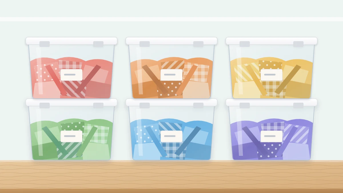 Six clear lidded bins stacked two high, each holding fabric scraps of one color family from red to purple