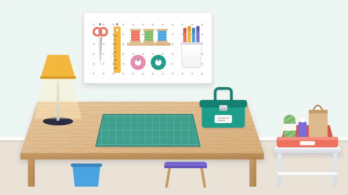A clear work table with only a lamp, a closed caddy and a cutting mat, beside a small inbox tray holding a few new supplies