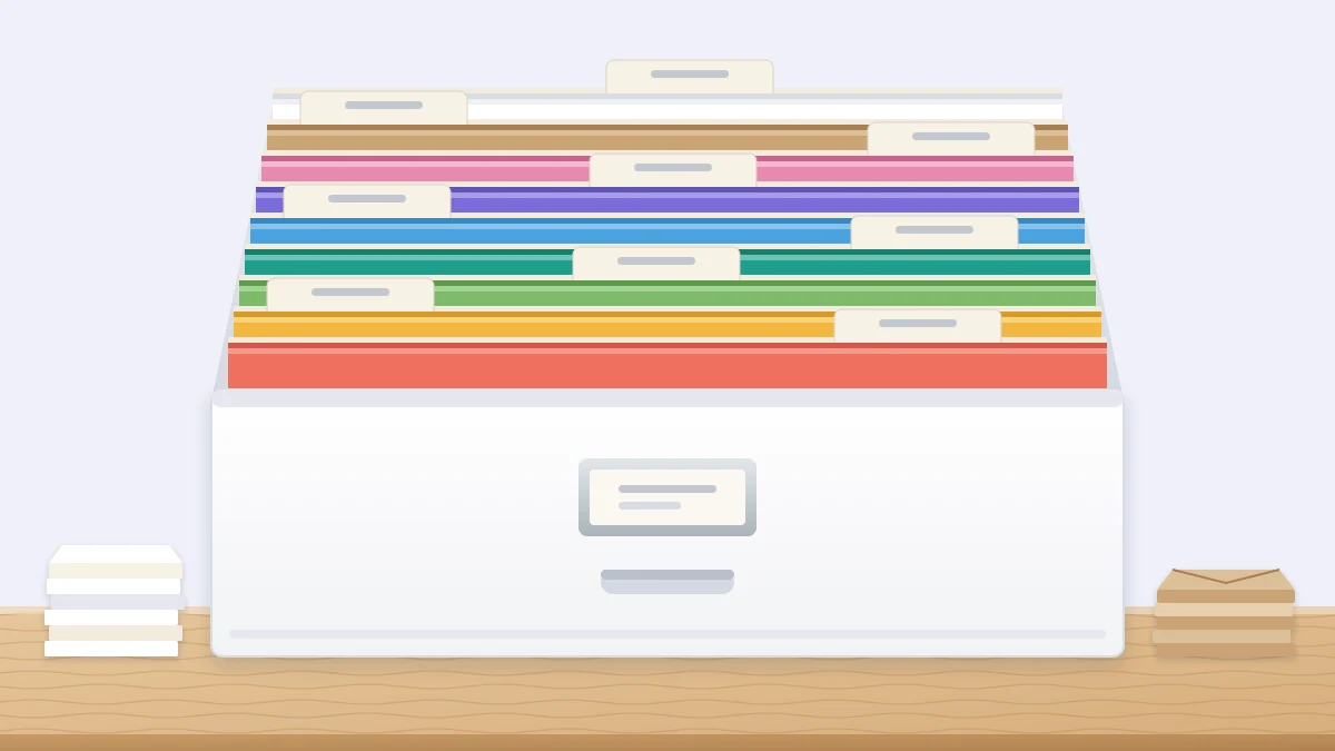 An open file box filled with cardstock sheets standing upright in a full color spectrum, separated by dividers with blank tabs