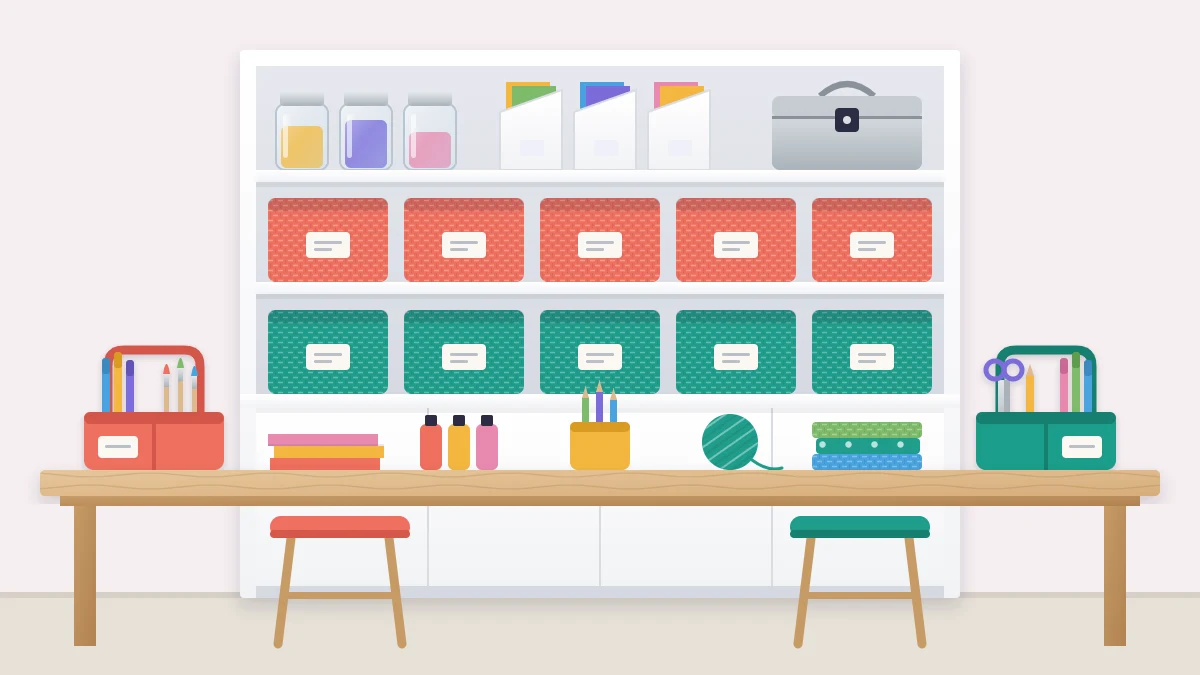 A long work table with two tidy work areas, each with a desktop caddy in its own color, and a shelf unit behind with a row of coral bins and a row of teal bins